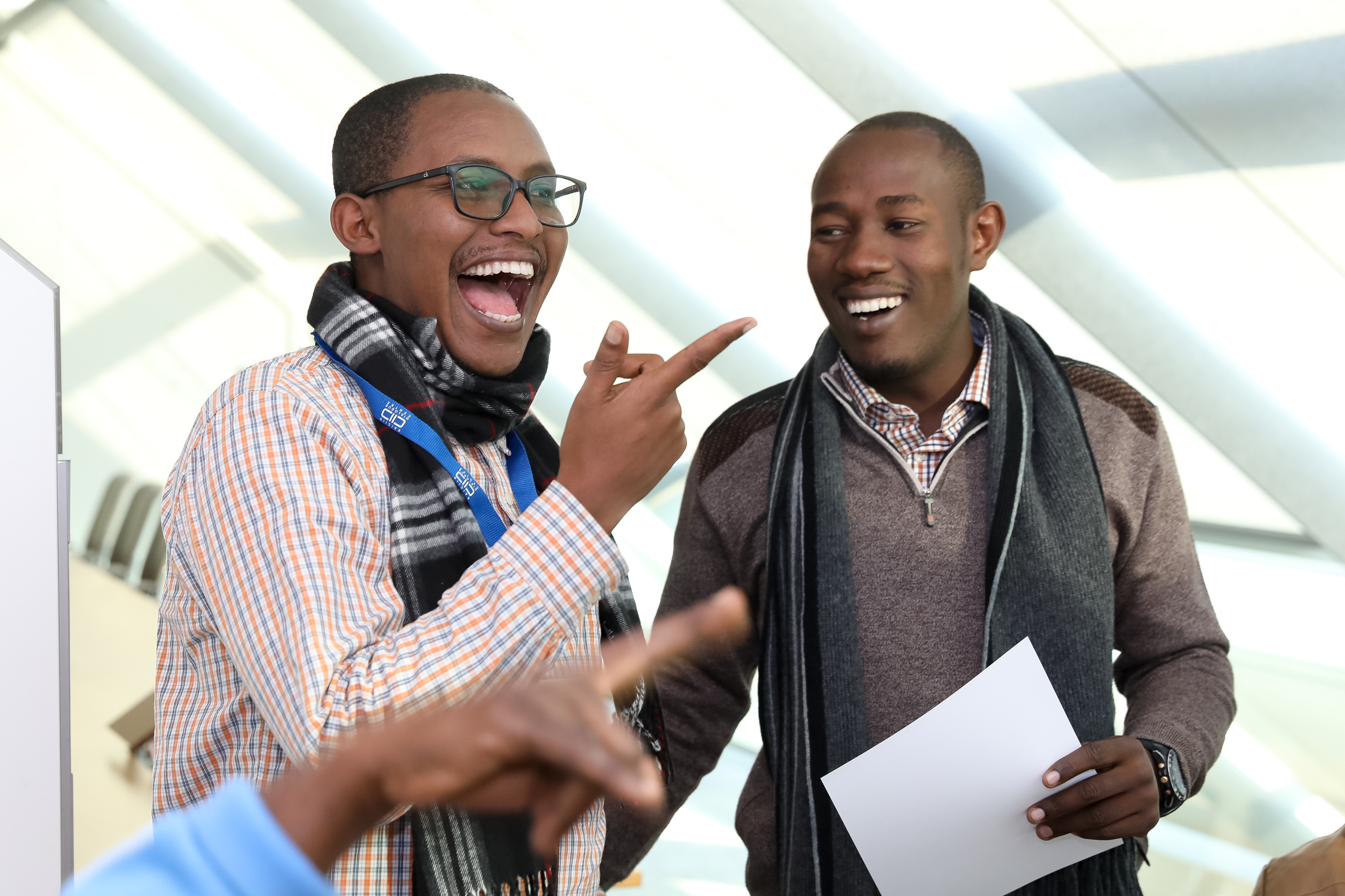 Tsegahun Assefa Adugna and a colleague laugh together at a KAICIID Fellows Training 