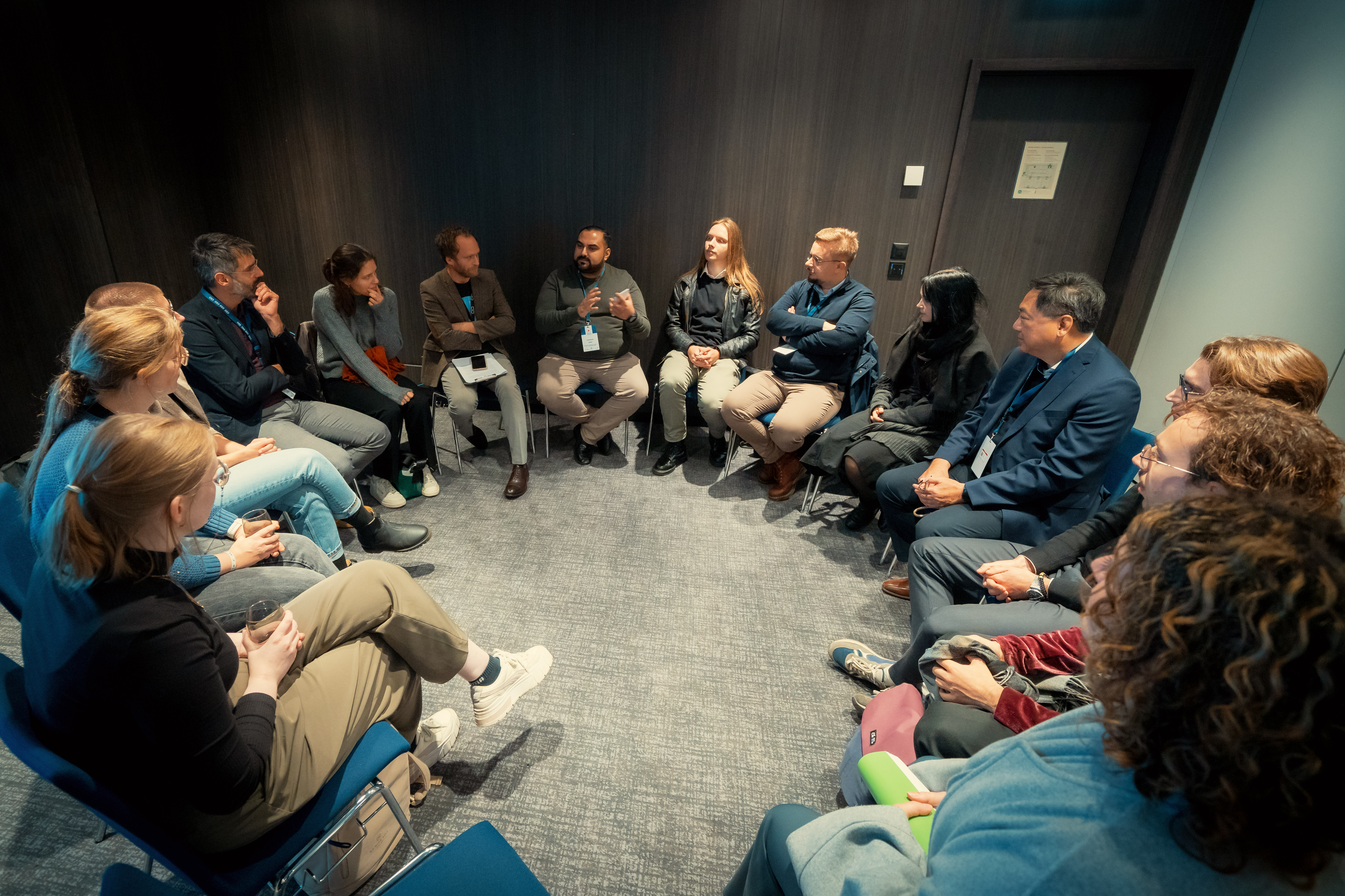 Group of people gathering in a circle, exchanging knowledge. 