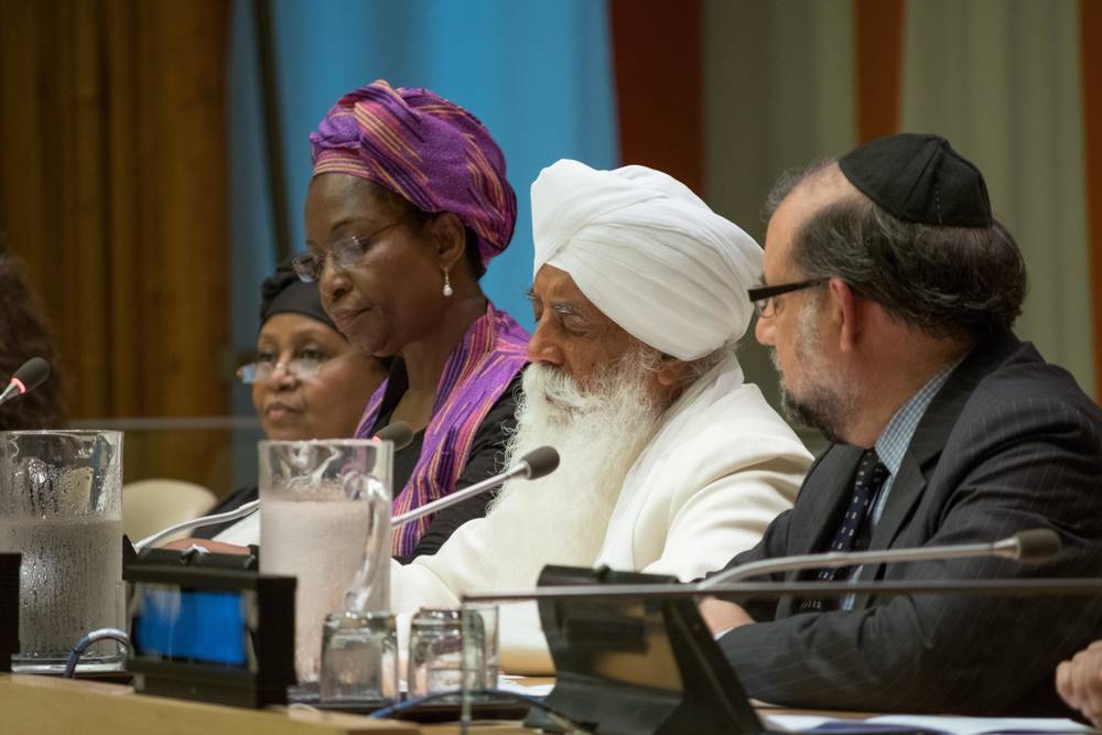 Photo by Michael Palma Mir Four religious leaders sit together at table