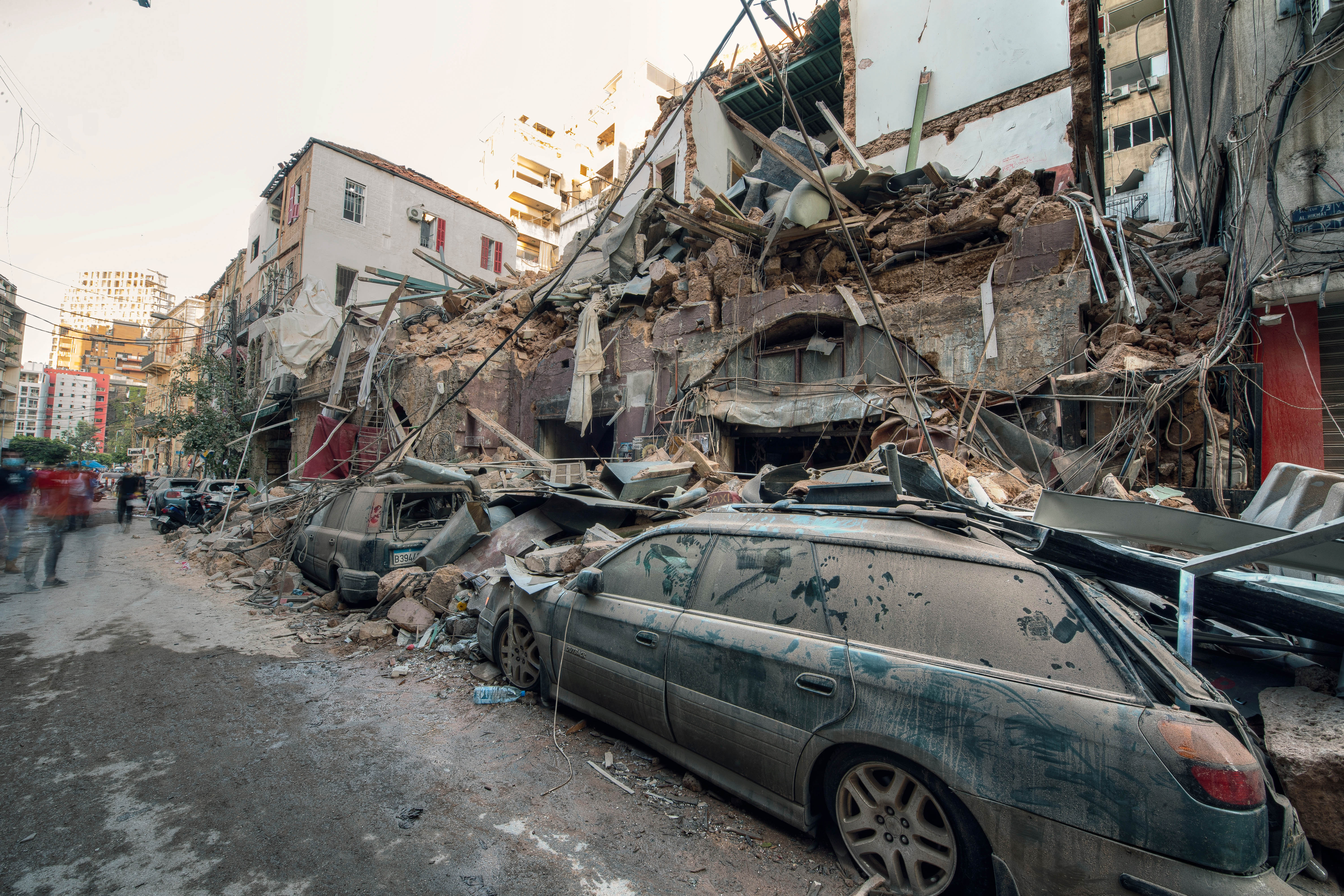 Debris from collapsed houses has fallen on a smashed car during the Beirut explosion