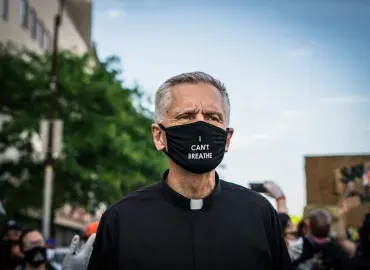 Priest wears mask that says "I can't breathe" at protest against racism