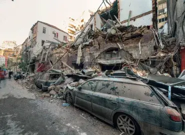 Debris from collapsed houses has fallen on a smashed car during the Beirut explosion