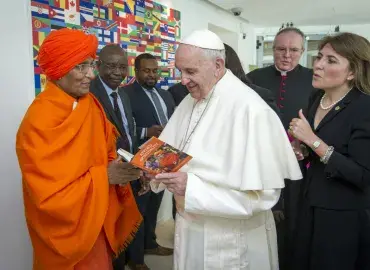 Board Member Swami Agnivesh presents a copy of his book to H.H Pope Francis. Photo: Swami Agnivesh