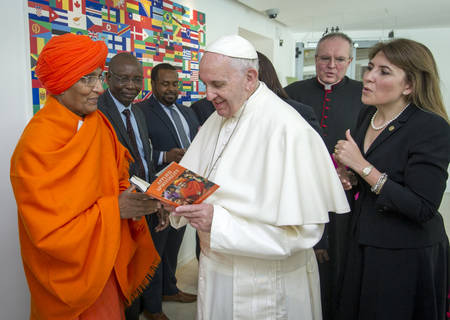 Board Member Swami Agnivesh presents a copy of his book to H.H Pope Francis. Photo: Swami Agnivesh Board Member Swami Agnivesh presents a copy of his book to H.H Pope Francis. Photo: Swami Agnivesh