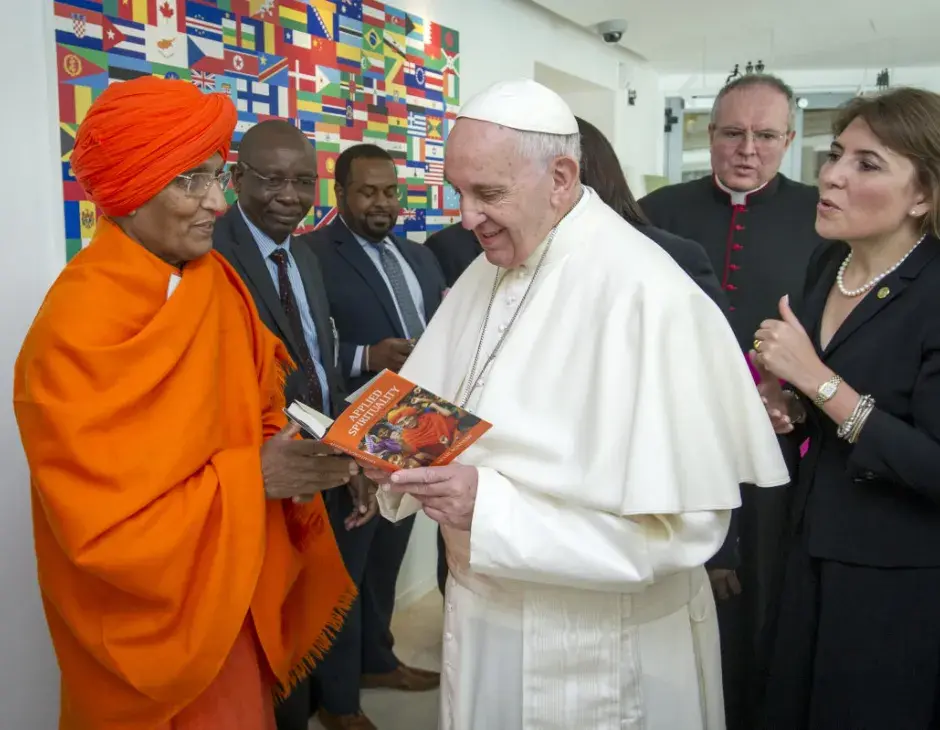 Board Member Swami Agnivesh presents a copy of his book to H.H Pope Francis. Photo: Swami Agnivesh