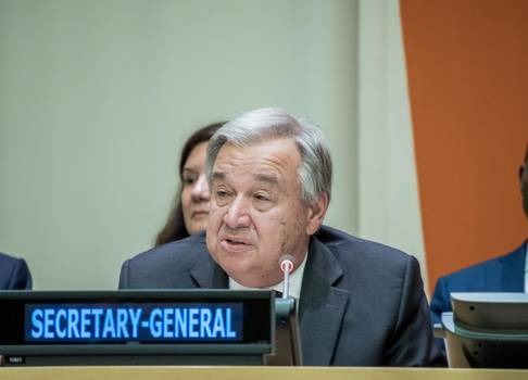 UN Secretary General Guterres sits at table 