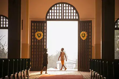 Two boys pass through the main doors the Cathédrale Notre-Dame of Bangui. Photo: Kaleb Warnock/KAICIID