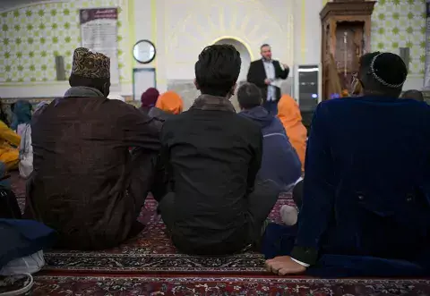 The Fellows look on as they receive a presentation from the Centre’s Imam on the tenants and structure of religious worship in a mosque. Vienna Houses of Worship Tour 2