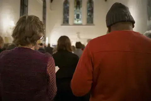 Brahmachari Jagrat Chaitanya, a Fellow from Sri Lanka reads along in the hymnal with one of the members of the church. Photo: KAICIID Vienna Houses of Worship Tour 8