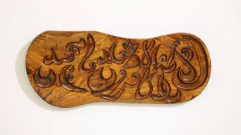Khaled Zagdoud's art project "One United Nations" is a series of modern calligraphies carved on wood