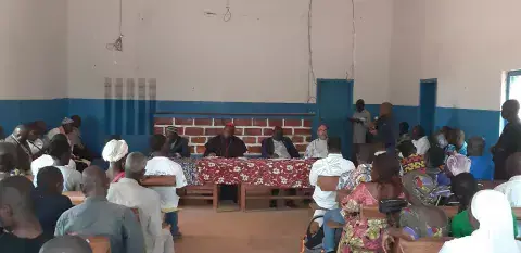 Reverend Nicolas Guerekoyame-Gbangou, Cardinal Dieudonné Nzapalainga and Imam Abdoulaye Ouasselogue address a crowd of people at a town hall meeting