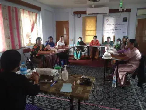 Women in a classroom discuss media literacy at a training in Myanmar sponsored by KAICIID