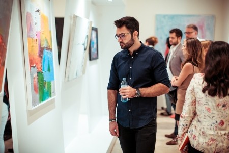 Spectators at the Bridges Exhibition at the KAICIID Dialogue Centre. Photo: David Pan. Spectators at the Bridges Exhibition at the KAICIID Dialogue Centre. Photo: David Pan.